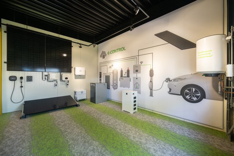 Showroomopstelling met zonnepaneel, thuisbatterij, laadpaal en E-Control